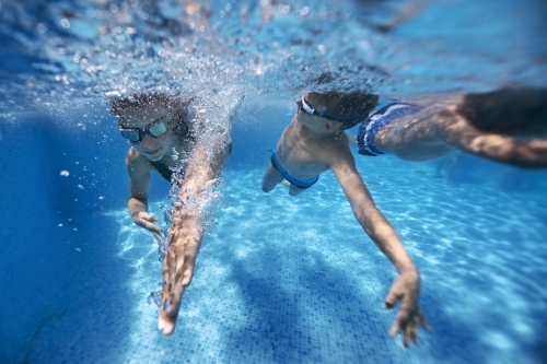 kids swimming race in pool